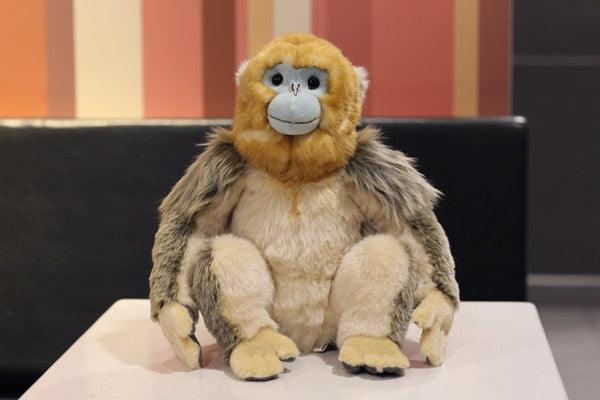 Realistischer sitzender goldener Affe Plüschtier